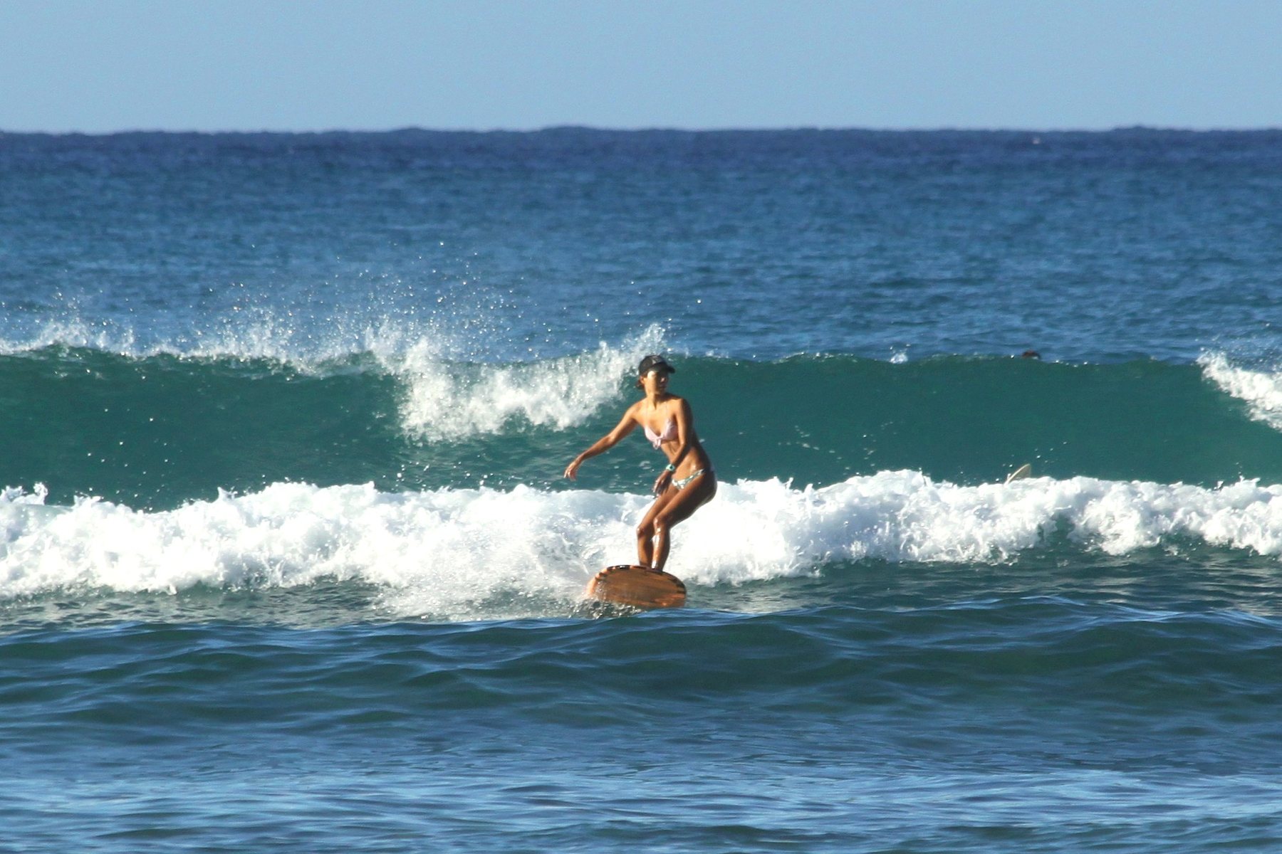 A surfer riding a wave at Waikiki Beach in Honolulu, Hawaii