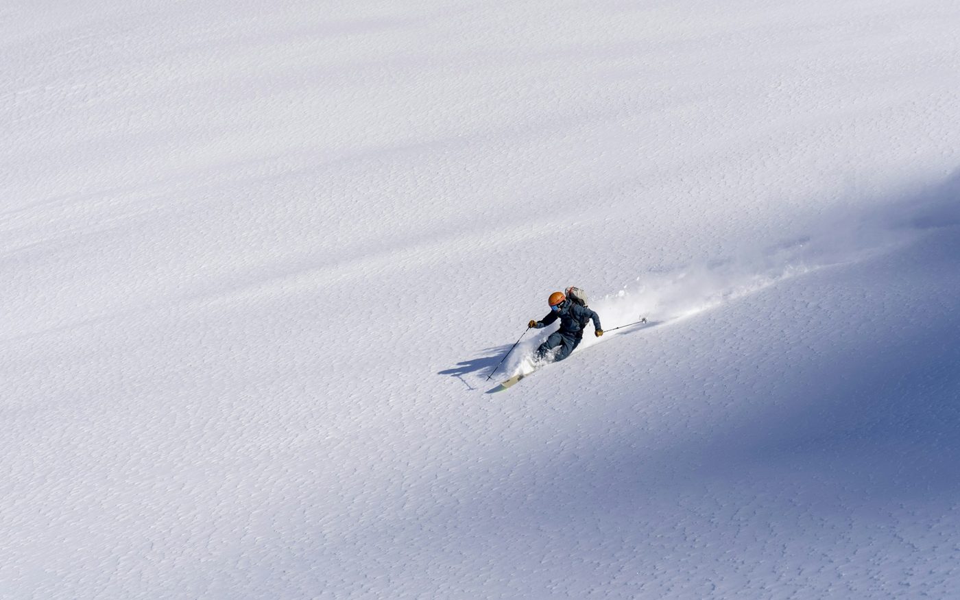 Skier descending a powder slope in Hokkaido