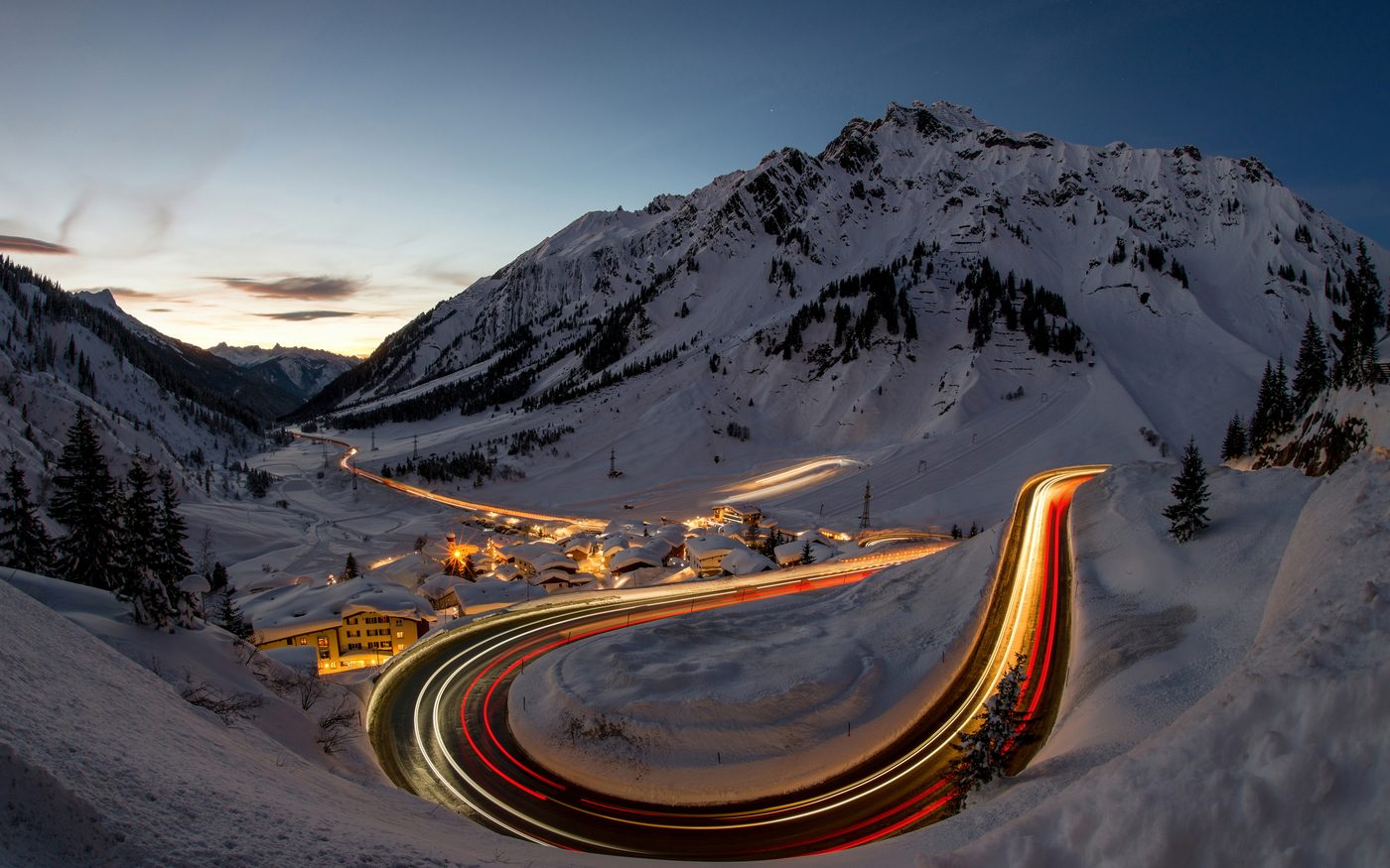 Lights of an Arlberg village at dusk in deep snow