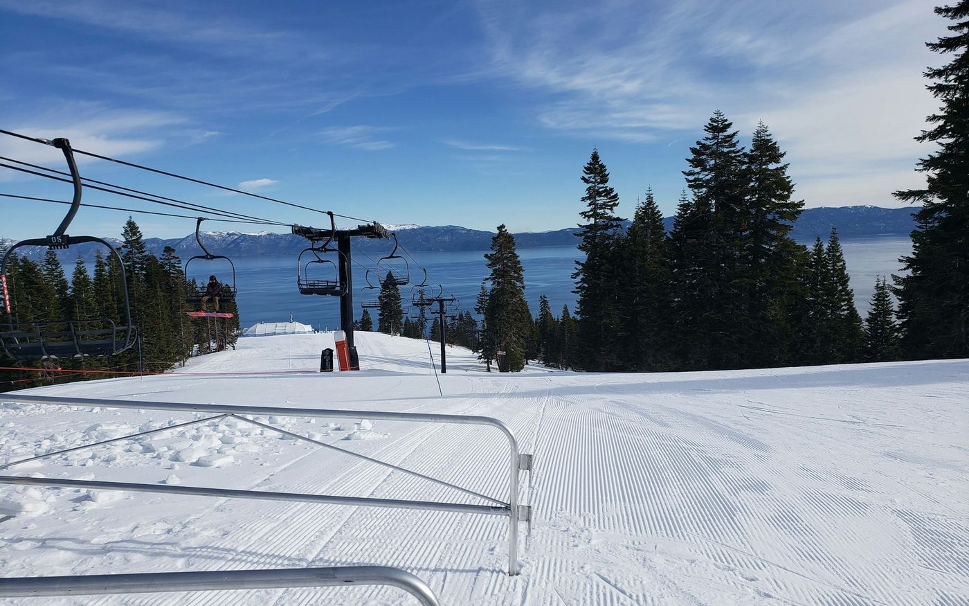 Groomed ski run and chairlift above Lake Tahoe