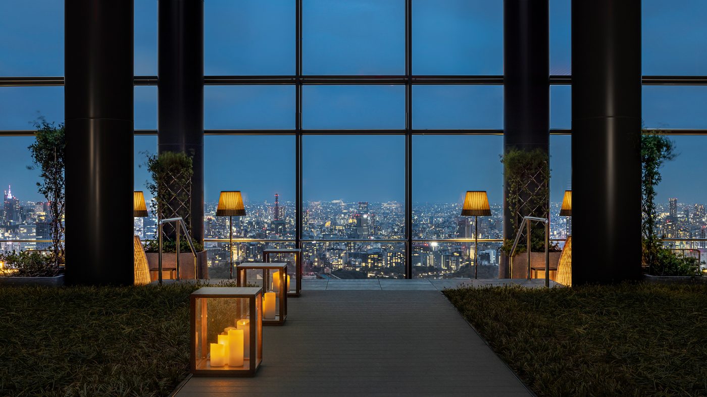 The 40th-floor terrace at Bvlgari Hotel Tokyo, lanterns lit against the night skyline