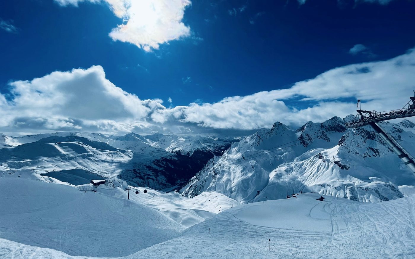 Snow-covered Arlberg slopes with a ski lift above St. Anton