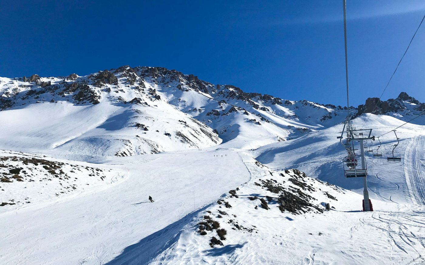 Cable car over snow-covered mountains at Las Leñas