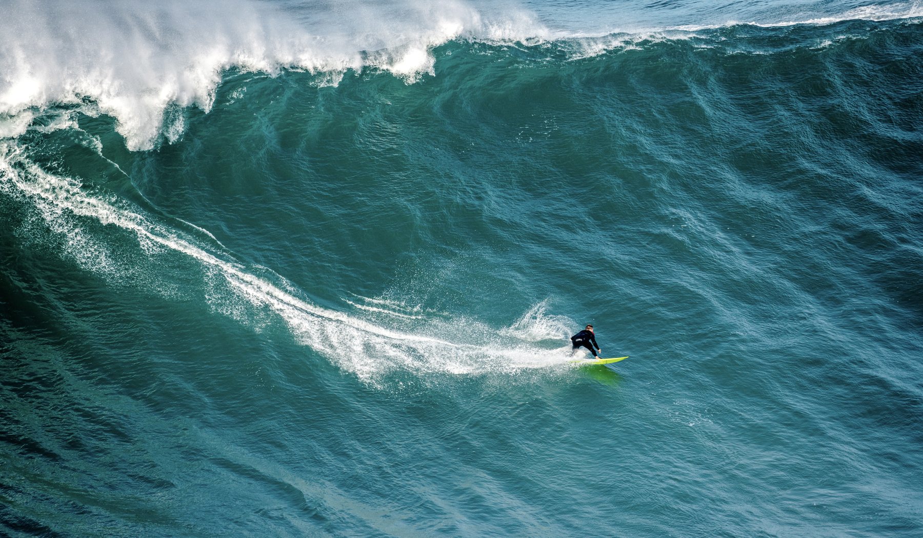 A roughly ten-metre wave breaking at Praia do Norte in Nazaré, Portugal