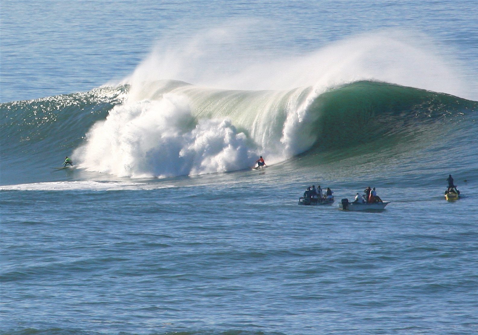 Surfers in the water at the Mavericks big-wave break off Half Moon Bay, California